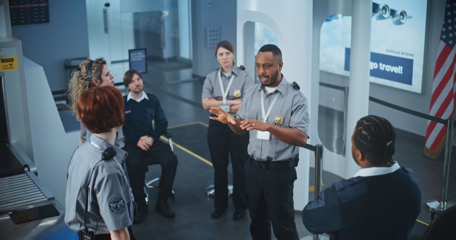TSA Officer Holding Briefing, Providing Instruction to Team of Workers About Scanning Procedures